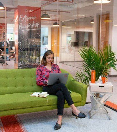 Woman in an office sitting with laptop